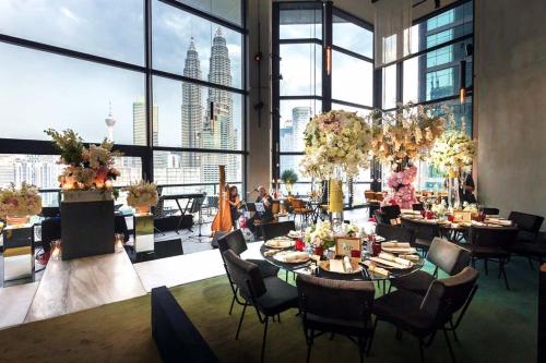 a dining room with a view of the city at Exclusive The Troika Luxury Apartment in Kuala Lumpur