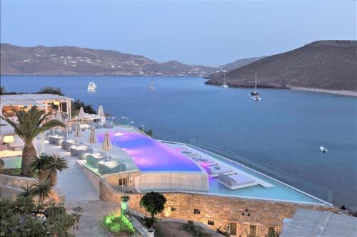 a large boat docked next to a body of water at Panormos Village Hotel in Mykonos