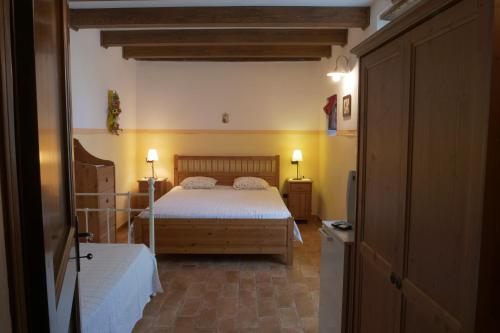 a bedroom with a bed and a television in it at La Piana Dei Castagni in Castel dʼAiano