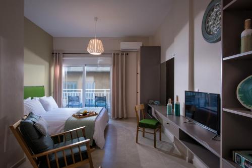 a bedroom with a bed and a tv in a room at Downtown Central Apartments in Heraklio