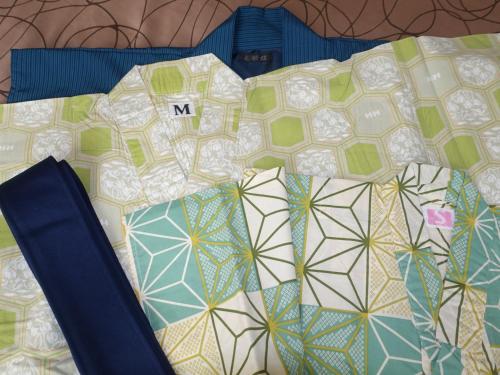 a group of ties sitting on a bed at Hakuba Highland Hotel in Hakuba