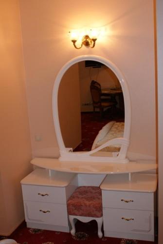 a white dressing table with a mirror on it at Nelly Apart in Kyiv
