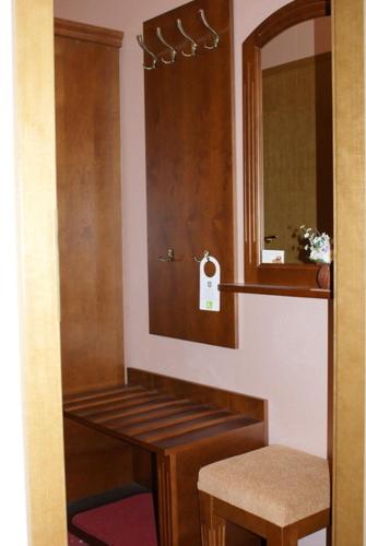 a bathroom with a sink and a mirror and a stool at Nelly Apart in Kyiv