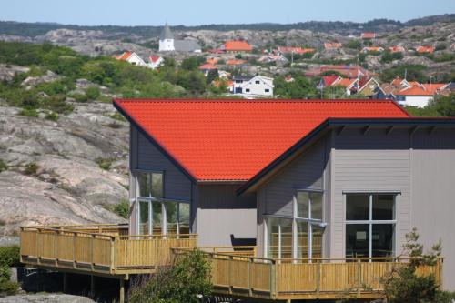 a house with an orange roof on a hill at Hav & Logi Skärhamn in Skärhamn