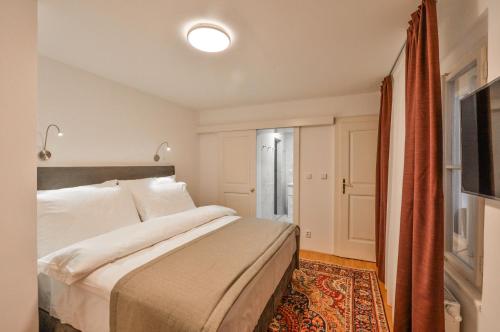 a bedroom with a large bed and a window at Romantic Apartment Prague near Charles Bridge in Prague