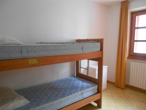 two bunk beds in a room with a window at Residence Le Orchidee in Bormio
