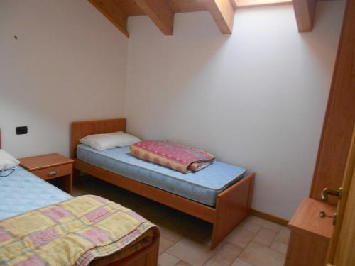 a room with two beds in a room at Residence Le Orchidee in Bormio