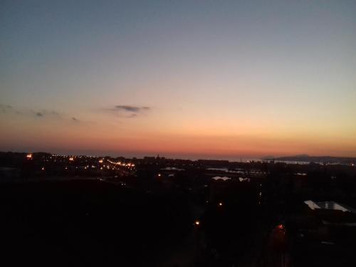 a view of a city at sunset at Palazzo del Mare in Naples