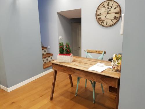 a dining room with a table and a clock on the wall at La Terrazza di Carolina in Agrigento