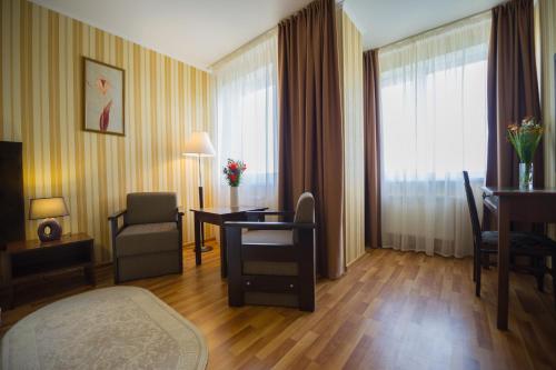 a hotel room with a desk and a room at Lisova Pisnia Resort Hotel in Truskavets
