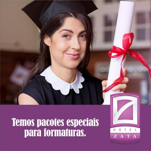 a woman holding up a diploma and a graduation at Hotel Zata - Econômico in Criciúma