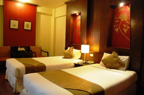 Postel nebo postele na pokoji v ubytování Chiangmai Gate Hotel