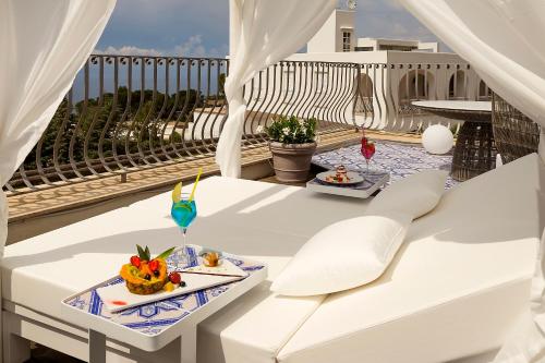 a table with a tray of food on a balcony at Hotel Villa Blu Capri in Anacapri