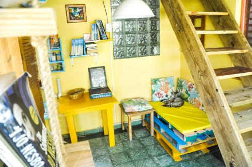 a room with a desk and a table with a bench at Casa Delfin Guest House in Las Terrenas