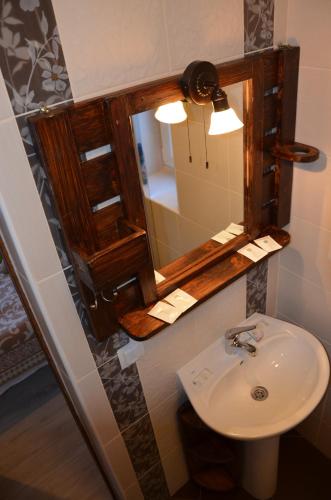a bathroom with a sink and a mirror at Fachwerk in Yaremche
