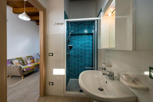 a bathroom with a sink and a glass shower at Casa Vacanza Saraceno in Castellammare del Golfo