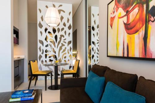 a living room with a couch and a table at Fraser Suites Riyadh in Riyadh