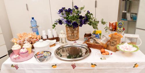 a table with a bunch of food and flowers on it at B&B Magna Grecia di Gallitelli in Taranto
