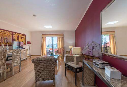 a living room with purple walls and a table and chairs at Luxury Apartment, Marina, Beach & Pool in Portimão