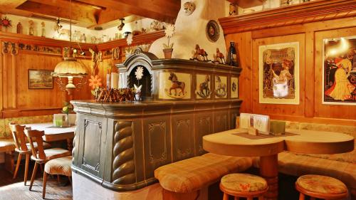 a restaurant with a bar with a table and chairs at Hotel Restaurant Falken in Baiersbronn