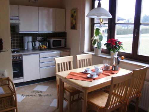 a kitchen with a wooden table with chairs and a table and a table at Apartment Dreier - Salzburger Land in Abtenau
