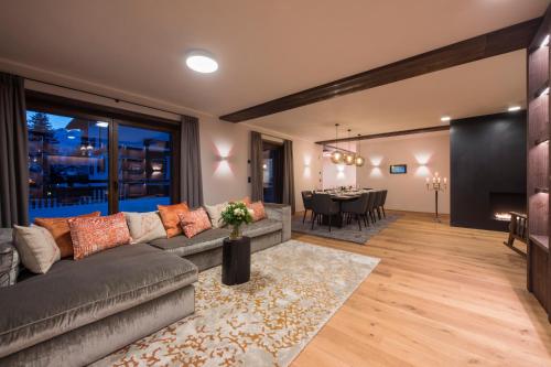 a living room with a couch and a dining room at Nidus Luxury Apartments in Lech am Arlberg