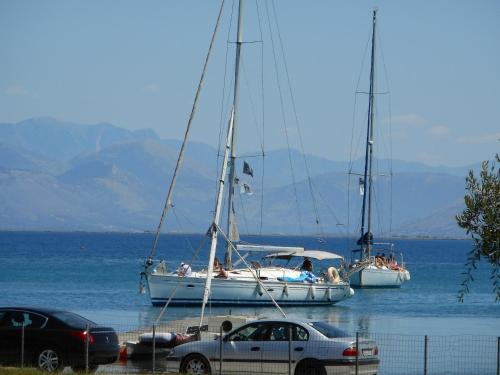 two sailboats are docked in a body of water at Egrypos Hotel in Petrití