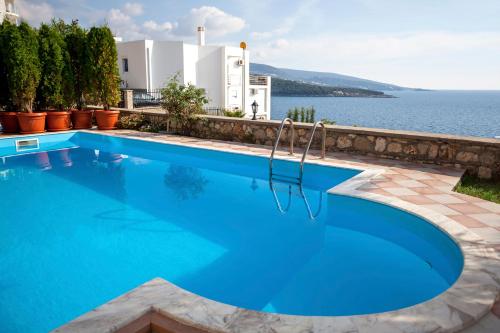 a swimming pool with a view of the water at Royal Villas in Dobra Voda