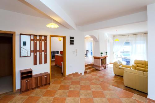 a living room with a couch and a table at Royal Villas in Dobra Voda