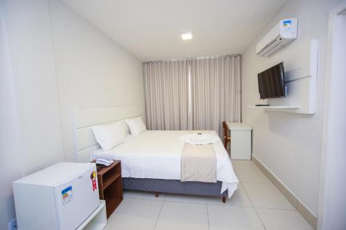 Giường trong phòng chung tại Hotel Portal Guanambi