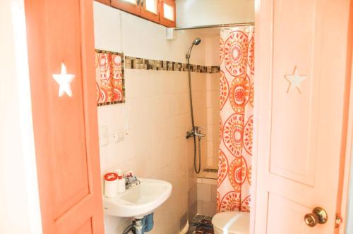 a small bathroom with a sink and a toilet at Casa Delfin Guest House in Las Terrenas