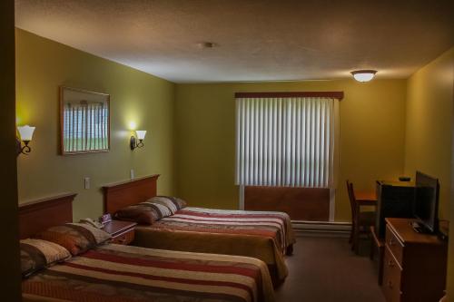 Hotel Harbour Grace tesisinde bir odada yatak veya yataklar
