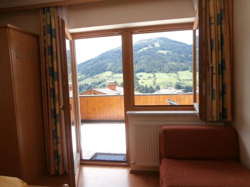 a room with a large window with a view of a mountain at Haus Kristall in Alpbach