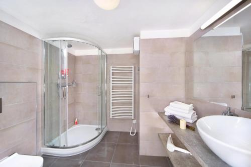 a bathroom with a tub and a sink and a shower at Apartmány Hromovka in Špindlerův Mlýn