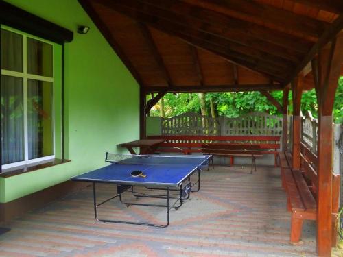 a ping pong table sitting inside of a building at Agrotourist Maryska Małe Leźno in Małe Leżno