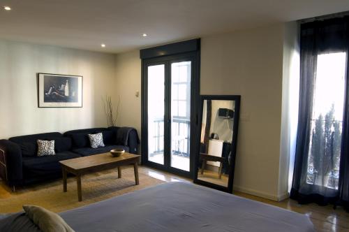 a living room with a couch and a table at Apartamentos Ondoloin in Vitoria-Gasteiz