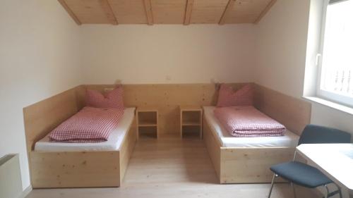 a room with two beds in the corner of a room at Gästehaus Engelhard Pension in Karbach