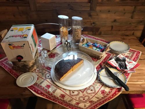 a table with a slice of cake on a plate at Rifugio Luna Nascente in San Martino