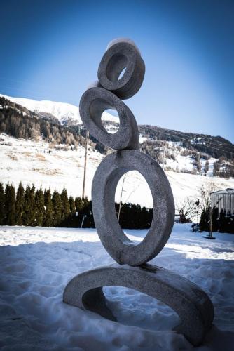 a large metal sculpture sitting in the snow at Haus Bergkastelblick in Nauders