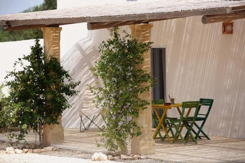 a porch of a house with a table and chairs at Masseria Caposella in Ugento