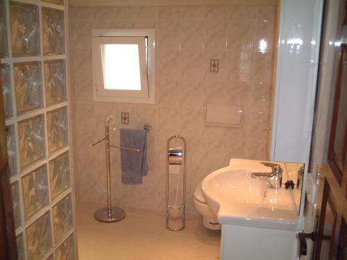 a bathroom with a sink and a toilet and a shower at Casa Sol in L'Estartit