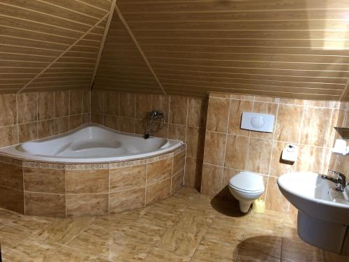 a bathroom with a tub and a toilet and a sink at Agata in Wisła