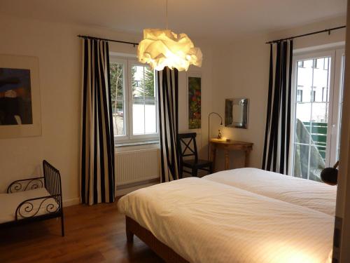 a bedroom with a bed and a chandelier at Schwarzwald light in Freudenstadt