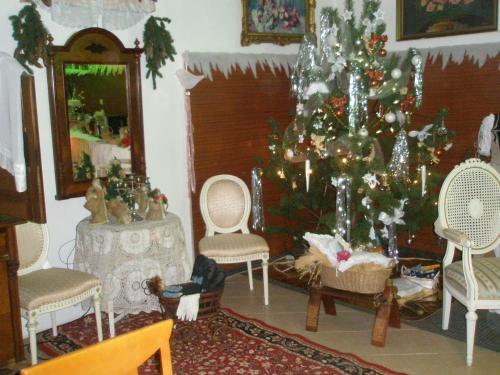a living room with a christmas tree and chairs at Pension Jana Tatrovice in Tatrovice