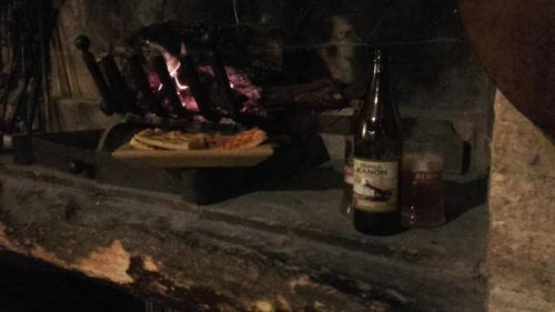 a bottle of beer and a plate of food in a fireplace at B&B Alsoci-La Tasca in Marsciano