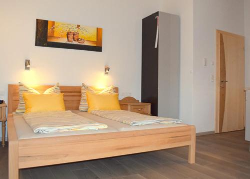 a bed with yellow pillows on top of it at Flatscher‘s in Niederau