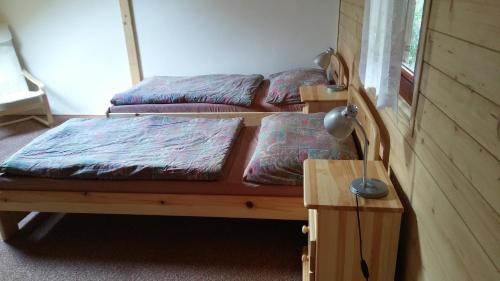 two twin beds in a room with at Autocamp Skalice in Slapy