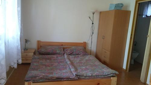 a small bedroom with a bed and a dresser at Autocamp Skalice in Slapy