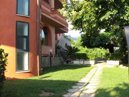 a house with a green yard next to a building at Affittacamere Il Colle in Faicchio