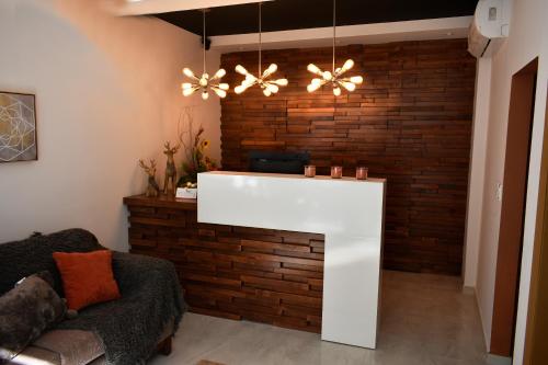 a living room with a white counter in front of a brick wall at California Comfort & Suites in Los Algodones